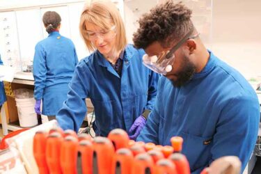 professor and student in chemical engineering lab with samples in tubes