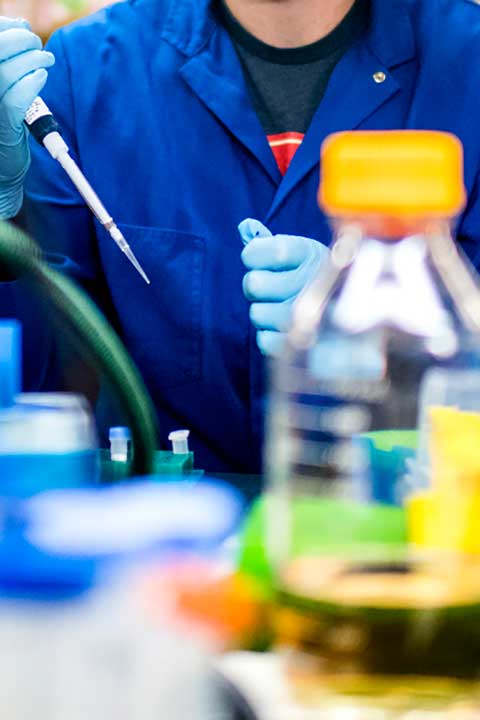 Student using pipette in the lab.