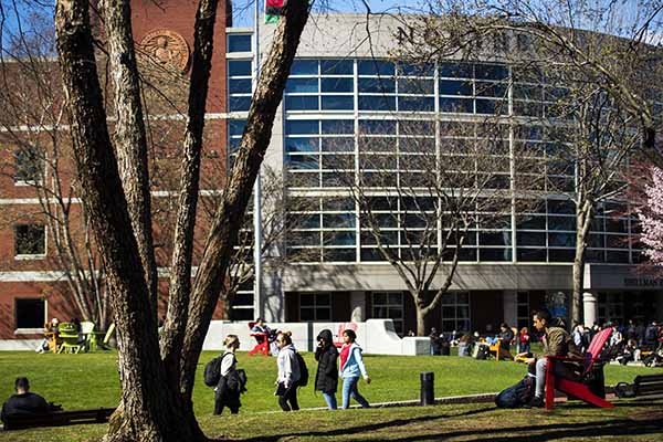 building with Northeastern University name and students walking outside